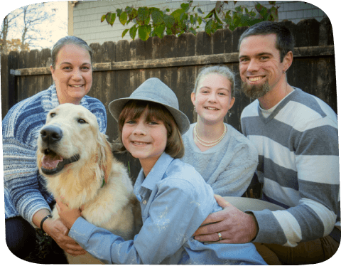 A photo of the Mackechnie family: Dawn, her partner, two children, and their dog